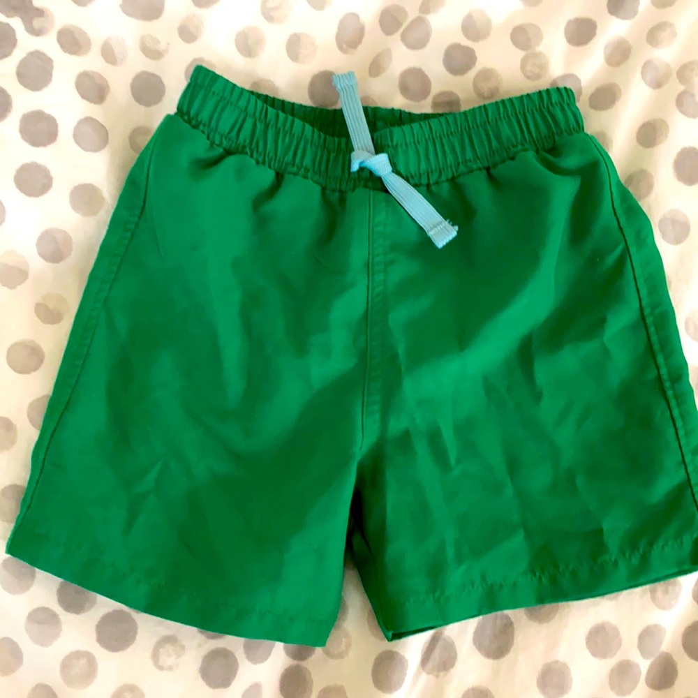 Primary green swim trunks, size 18-24 months.